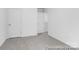 A bedroom with neutral carpet and walls, and featuring multiple doors and wall outlets at 614 Wabash Ave # 9, Charlotte, NC 28208