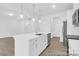 Well-equipped kitchen island with a stainless steel sink, stainless steel appliances, modern fixtures, and a view of the stairs at 614 Wabash Ave # 9, Charlotte, NC 28208