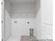 Functional laundry room features built-in shelving, providing efficient storage solutions at 614 Wabash Ave # 9, Charlotte, NC 28208