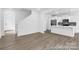 Bright open-concept living space featuring a kitchen island, stainless appliances, and easy access to the staircase at 614 Wabash Ave # 9, Charlotte, NC 28208