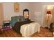 Cozy bedroom featuring hardwood floors, a comfortable bed and matching decor at 6148 Meadow Rose Ln, Charlotte, NC 28215