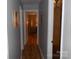 Narrow hallway with neutral walls leading to other rooms in the home at 6148 Meadow Rose Ln, Charlotte, NC 28215