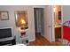 Hallway with neutral walls leading to a bathroom and other rooms at 6148 Meadow Rose Ln, Charlotte, NC 28215