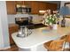 Well-lit kitchen featuring an island with seating and stainless steel appliances at 6148 Meadow Rose Ln, Charlotte, NC 28215