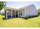 Wide-open backyard featuring a screened patio with seating, a lush green lawn, and neatly landscaped surroundings at 658 Gardenbrook Trl, Belmont, NC 28012
