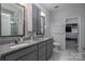 Bathroom features double vanities with granite countertops and a walk-in shower at 658 Gardenbrook Trl, Belmont, NC 28012