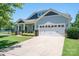 Inviting two-story home with a covered porch, two-car garage, and manicured lawn on a bright, sunny day at 658 Gardenbrook Trl, Belmont, NC 28012