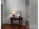 Inviting hallway with dark hardwood floors and decoratively furnished table, creating an elegant and welcoming entrance at 658 Gardenbrook Trl, Belmont, NC 28012