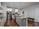 Modern kitchen with stainless steel appliances, an island, and wood flooring at 658 Gardenbrook Trl, Belmont, NC 28012