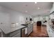 Open-concept kitchen flowing into the living room; island with seating, stainless steel appliances at 658 Gardenbrook Trl, Belmont, NC 28012