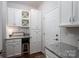 Functional laundry room featuring ample cabinet space, granite countertops, and modern finishes at 658 Gardenbrook Trl, Belmont, NC 28012