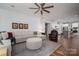 Hardwood floored living room with large sectional sofa open to kitchen at 658 Gardenbrook Trl, Belmont, NC 28012