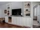 Comfortable living room with built-in shelving, cabinets, and hardwood floors at 658 Gardenbrook Trl, Belmont, NC 28012