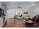 Spacious living room featuring a large sectional, hardwood floors, and a ceiling fan at 658 Gardenbrook Trl, Belmont, NC 28012