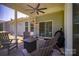 Inviting screened patio with comfortable seating, ceiling fan, and a grill, perfect for outdoor entertaining at 658 Gardenbrook Trl, Belmont, NC 28012