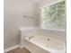 Bright bathroom featuring an oversized tub under a window, providing natural light at 6603 Brenock Ln, Charlotte, NC 28269