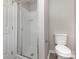 Updated bathroom features a toilet and tiled shower with glass door at 6603 Brenock Ln, Charlotte, NC 28269