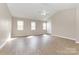 Spacious bedroom with lots of natural light, ceiling fan and wood-look floors at 6603 Brenock Ln, Charlotte, NC 28269