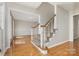 Inviting foyer features hardwood floors, a staircase with carpeted steps, and views into the adjacent living room at 6603 Brenock Ln, Charlotte, NC 28269