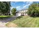 Charming two-story traditional home with a welcoming front porch, two-car garage, and landscaped front yard on a sunny day at 6603 Brenock Ln, Charlotte, NC 28269