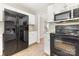 Bright kitchen features white cabinets, stainless steel appliances, and a large black refrigerator at 6603 Brenock Ln, Charlotte, NC 28269