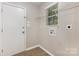Bright laundry room features a window, plenty of storage and an exterior door at 6603 Brenock Ln, Charlotte, NC 28269