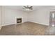 Spacious living room with vinyl floors, a cozy fireplace, and large windows offering lots of natural light at 6603 Brenock Ln, Charlotte, NC 28269
