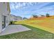 Backyard featuring a patio, grassy yard, and surrounding neighborhood homes at 7079 Waterwheel Sw St, Concord, NC 28025