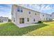 Backyard featuring patio, grassy yard, and vinyl siding of the home at 7079 Waterwheel Sw St, Concord, NC 28025