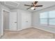 Bedroom featuring carpet, ceiling fan, walk-in closet, and windows for plentiful natural lighting at 7079 Waterwheel Sw St, Concord, NC 28025