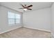 Bright bedroom features neutral tones, ceiling fan, and large windows that provide ample natural light at 7079 Waterwheel Sw St, Concord, NC 28025