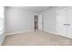 Neutral carpeted bedroom with a view of the landing showcases adjacent storage and ample natural light at 7079 Waterwheel Sw St, Concord, NC 28025