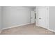 Bright carpeted bedroom with a neutral color scheme, adjacent doors, and ample closet space at 7079 Waterwheel Sw St, Concord, NC 28025