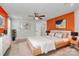 Cozy bedroom with an accent wall, decorative art, and a ceiling fan at 7079 Waterwheel Sw St, Concord, NC 28025