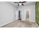 Serene bedroom with a ceiling fan, decorative accent wall, and an ensuite bathroom at 7079 Waterwheel Sw St, Concord, NC 28025