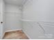 Spacious walk-in closet featuring built-in shelving at 7079 Waterwheel Sw St, Concord, NC 28025