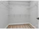 Spacious walk-in closet featuring built-in shelving at 7079 Waterwheel Sw St, Concord, NC 28025
