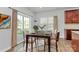 Bright dining area featuring a dark wood table, stylish chairs, and sliding glass doors for outdoor access at 7079 Waterwheel Sw St, Concord, NC 28025