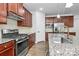 Well-appointed kitchen with granite countertops, stainless steel appliances, and ample cabinet space at 7079 Waterwheel Sw St, Concord, NC 28025