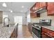 Modern kitchen featuring granite countertops, stainless steel appliances, and an open layout at 7079 Waterwheel Sw St, Concord, NC 28025
