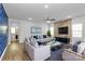 Inviting living room featuring modern furniture, a stone accent wall, and ample natural light at 7079 Waterwheel Sw St, Concord, NC 28025