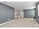 Open living area featuring neutral paint, carpet, and natural light at 7079 Waterwheel Sw St, Concord, NC 28025