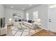 Bright and airy living room with plush seating, modern decor, and ample natural light at 7079 Waterwheel Sw St, Concord, NC 28025