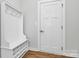 Functional mudroom area with built-in storage, coat hooks, and a convenient bench at 7079 Waterwheel Sw St, Concord, NC 28025