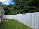 Spacious, green backyard features a tall, well-maintained white fence, perfect for privacy at 7315 Fig Ln, Charlotte, NC 28215