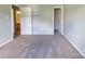 Bedroom with neutral carpet and gray walls with two open doorways at 7315 Fig Ln, Charlotte, NC 28215