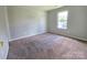 Bedroom with neutral carpet, light gray walls, and a bright window at 7315 Fig Ln, Charlotte, NC 28215
