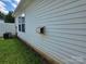 Exterior shot of the home's siding and an AC unit on a grassy area at 7315 Fig Ln, Charlotte, NC 28215