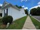 Well-maintained exterior view with a sidewalk, lush lawn, and tidy landscaping at 7315 Fig Ln, Charlotte, NC 28215