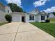 Charming single-story home with black shutters, lush lawn and a driveway leading to a one car garage at 7315 Fig Ln, Charlotte, NC 28215